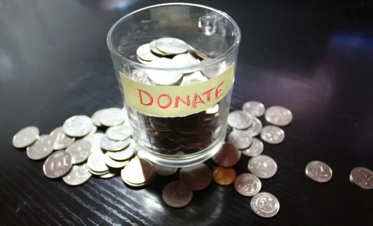 A glass of water with coins in it